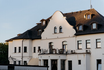 There is a large white building prominently featuring the letters eee displayed on its facade, making it easily recognizable from a distance