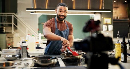 Chef, man and cooking vlog in kitchen for live streaming, recipe tutorial and filming food video in home. Content creation, happy influencer and recording online class for meal preparation or cuisine