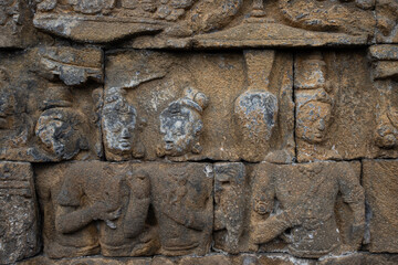 Wall with old stone statues in Borobudur Temple in Indonesia