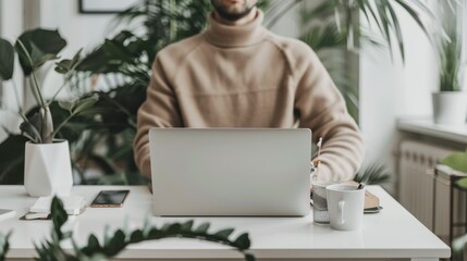 An office worker engages in remote tasks in a modern minimalist home office filled with plants during a bright daytime