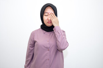 portrait of Asian, Indonesian woman wearing shirt and hijab yawning and stretching her hands. Lazy woman who looks sleepy, bored and tired. Isolated on white background