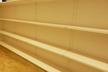 There are Empty White Shelving Units positioned in a beautifully Minimalist Space environment