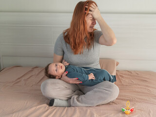 A woman holds a child in her arms and cries. Postpartum depression. 