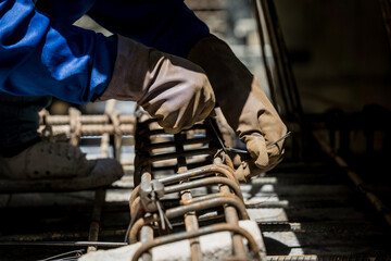 A group of builders is busy constructing a metal structure