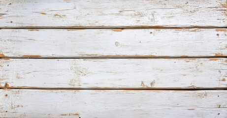 Weathered white wooden planks with rustic texture and chipped paint create charming backdrop. grainy surface adds character and warmth to any design project