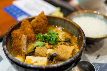 Deep fried fish fillet with soup bowl in restaurant