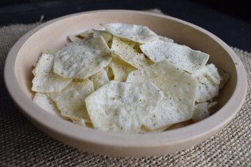 Potato chips in a wooden bowl