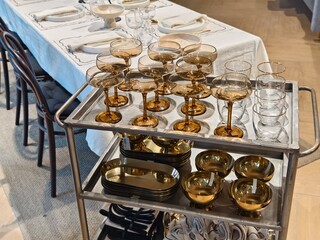 Elegant champagne glasses are arranged on a tray on a table