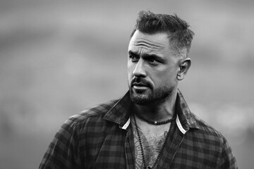 Portrait of the serious handsome man. A Hipster guy model headshot. Male serious face. Handsome serious man. Confident serious male model. Man looking proud. Closeup face of man outdoor. Elegant guy.