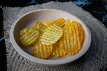 Potato chips in a wooden bowl