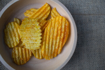 Potato chips in a wooden bowl