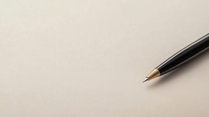 A black pen rests on a blank sheet of paper, symbolizing creativity and ideas.