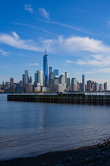Fototapeta premium The city skyline of New York City in USA, United States. Blue sky day with iconic buildings. New York City NYC Manhattan Downtown Skyline, viewed from Jersey City, USA.