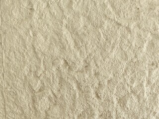 Grungy beige rough texture of a wall