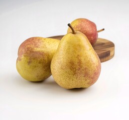 Two ripe pears with a speckled yellow and red hue isolated on white background