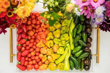 Handpicked colorful vegetables and flowers arranged in rainbow hue