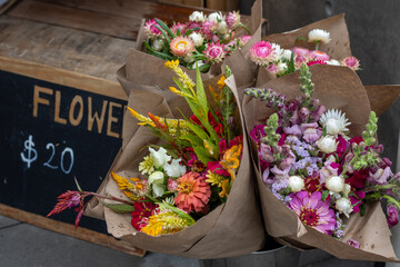 Colorful flower bouquets for sale at a farmers market stand