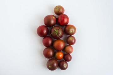 Dark-hued cherry tomatoes arranged highlighting organic freshness.