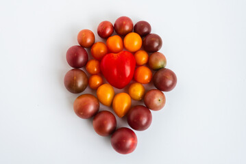 Cherry tomatoes arranged with a heart-shaped red tomato in the center.