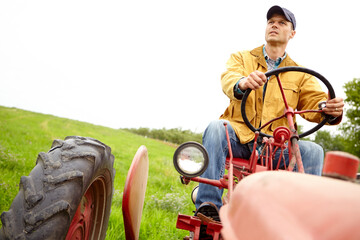 Driver, farming and man with tractor for driving, harvesting and tiling for cultivation in countryside. Field, male person or farmer with machine truck for agriculture, planting or plowing for growth