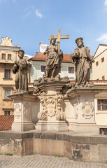 Sculpture of St Cosmas, Damian and Savior by Jan Oldrich Mayer on the Charles Bridge in Prague in Czech Republic