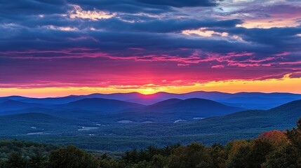 Fototapeta premium Vibrant Sunset Over Rolling Mountain Landscape