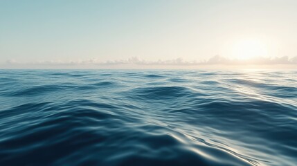 Fototapeta premium A wide expanse of calm ocean surface, with gentle waves and soft sunlight creating reflective patterns.