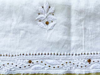 Intricate white on white lucknowni hand embroidered floral butta with silver badla on white cotton fabric