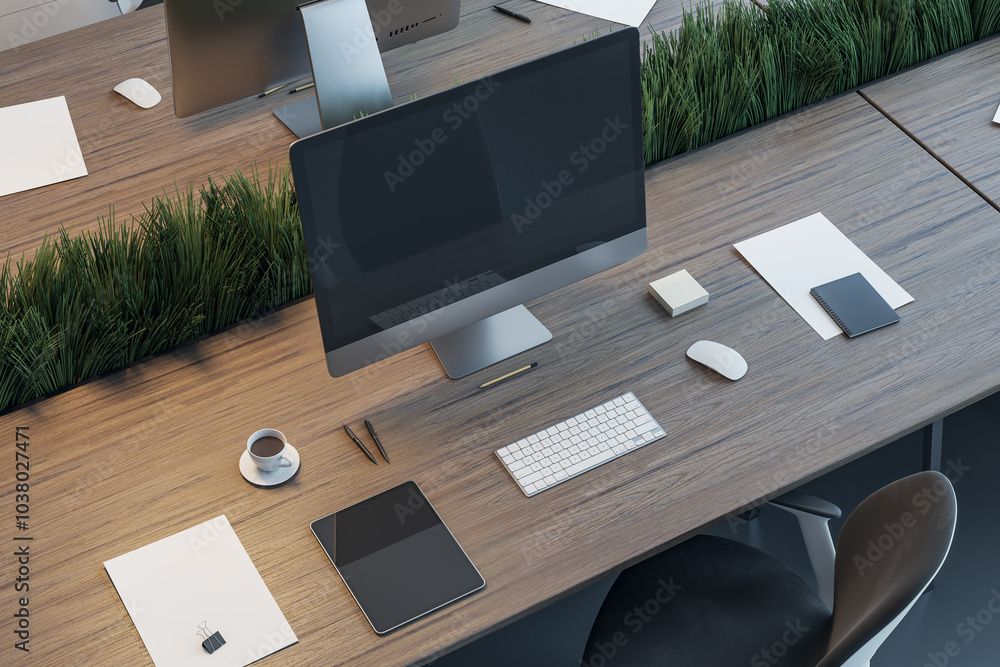Poster workspace in coworking office separated by a partition of green grass with modern computer blank dar