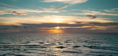 Sea beach with sky sunset or sunrise. Clouds over the sunset sea. Sunset at tropical beach. Nature sunset landscape of sunshine sea.