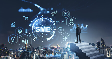 Man on concrete stairs, SME glowing hologram with business management icons