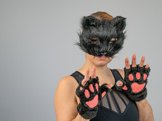 Portrait of a woman in a cat costume on a white background. Quadrober. 