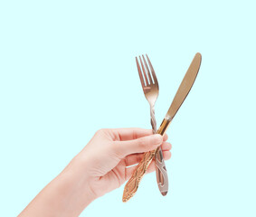 Knife and fork in hands isolated background