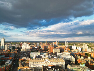 Obraz premium Aerial View of Greater Manchester City Centre and Tall Buildings During Golden Hour of Sunset. England UK. May 5th, 2024, High Angle Footage Was Captured with Drone's Camera