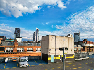 Obraz premium Aerial View of Greater Manchester City Centre and Tall Buildings During Golden Hour of Sunset. England UK. May 5th, 2024, High Angle Footage Was Captured with Drone's Camera