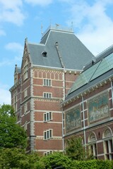 Old decorated houses in Amsterdam. There is a river next to them
