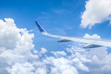 Airplane wing and sky cloudscape in stratosphere
