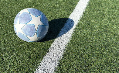 a soccer ball on the green grass in soccer stadium.