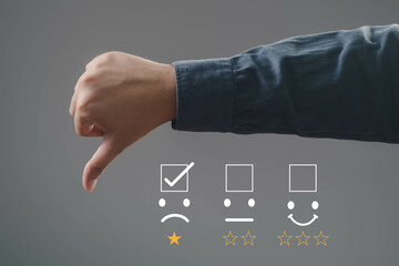 A hand showing a thumbs down gesture with feedback icons representing dissatisfaction. Ideal for...