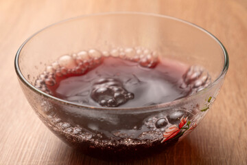 Red jelly is dissolved in a bowl for solidification. Preparation of gelatin desserts.