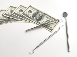 Dental mirror for oral cavity on lying on dollar bills