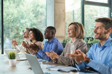 Obraz premium Image of colleagues clapping hands at seminar, listening speaker. Business education