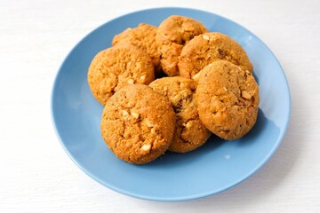 Cookies oatmeal raisin in blue  plate on white  background	