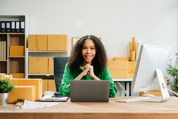 Young business owner woman prepare parcel box and standing check online orders for deliver