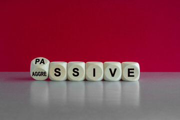 Turned a dice and changes the word passive to aggressive, or vice versa. Beautiful pink background....