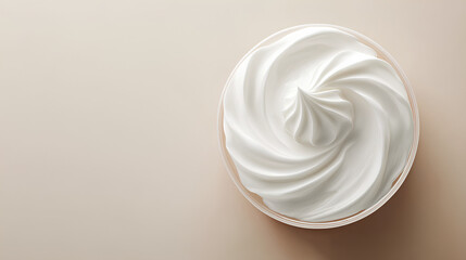 A close-up photo of white cream swirled in a jar, set against a tan background.