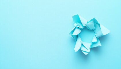 A crumpled piece of blue paper on a matching background, symbolizing creativity and brainstorming.