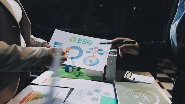 Group diverse Asia businesspeople talk ESG strategies risk management workshop, SDGs report, global warming, green finance and investment and net zero waste lifestyles in boardroom training building.
