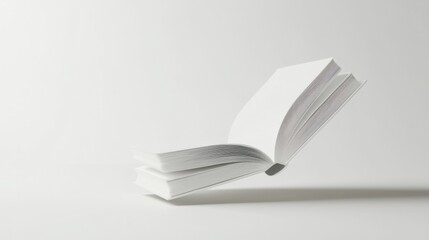 White book, floating in air, ceramic surface, white background