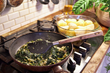 a man fries vegetables in a skillet on the stove